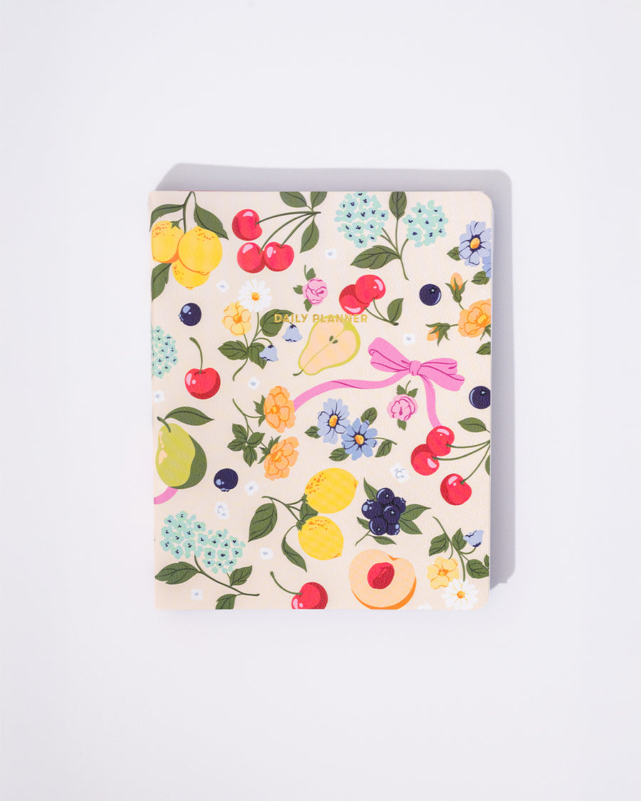 cream undated to do planner with all over colorful fruit and flower print and gold 'daily planner' across the front