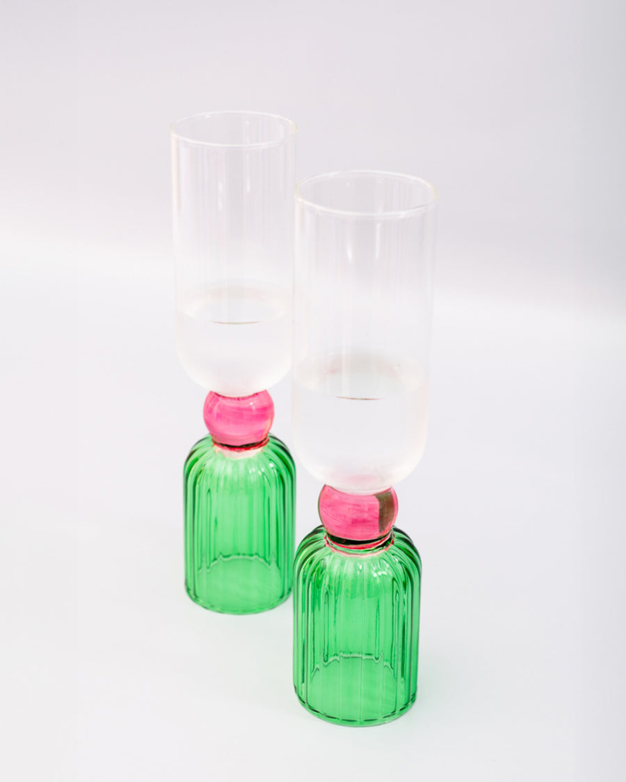 side view of set of 2 bar glasses with green base and pink center detail