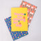 set of three notebook set: dark blue with tulip print, yellow with 'you're the cherry on top' typography, and pink mid century tulips