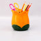 yellow tulip pencil cup with desk accessories in it