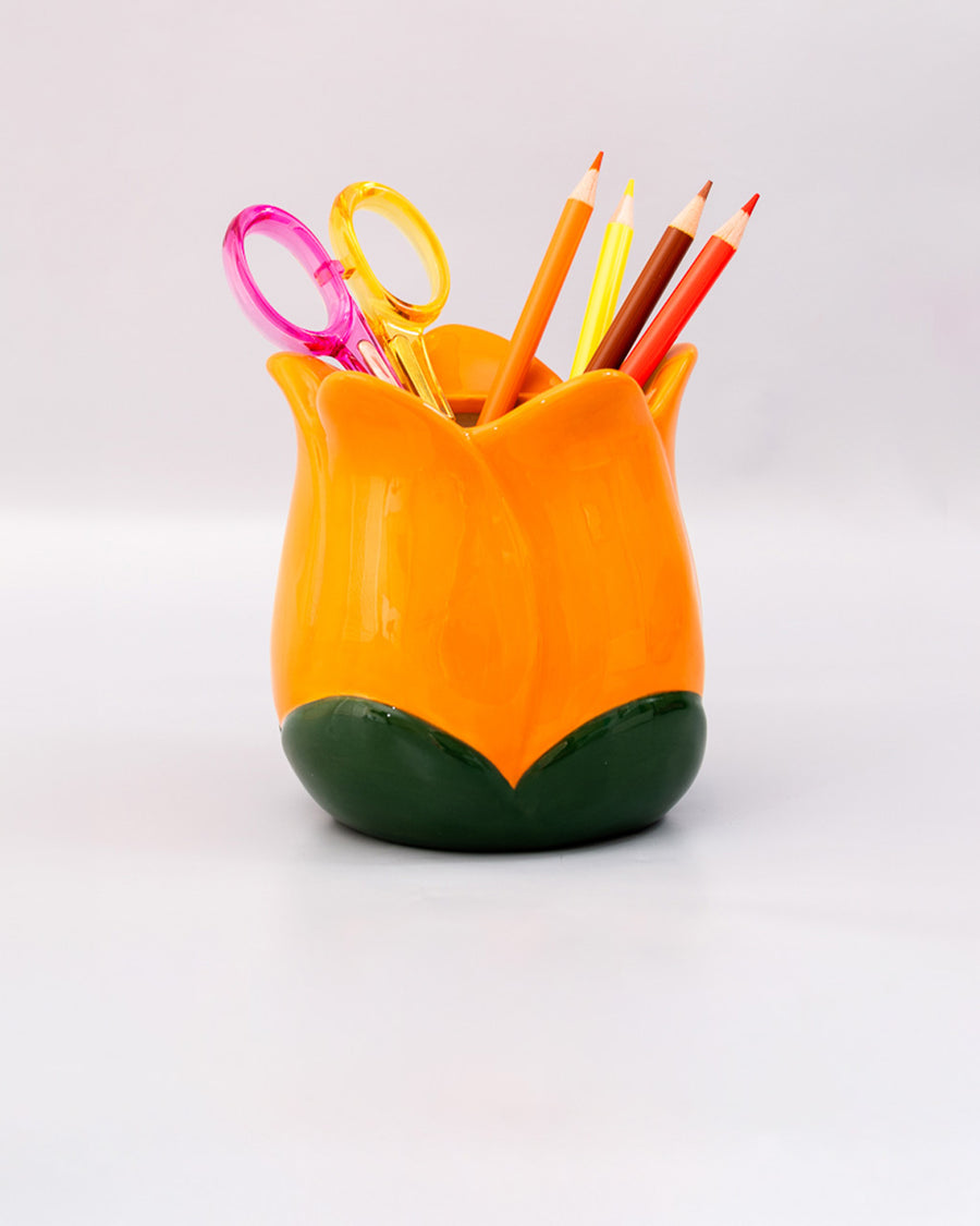 yellow tulip pencil cup with desk accessories in it