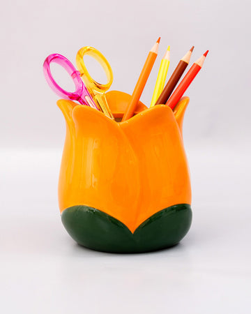 yellow tulip pencil cup with desk accessories inside