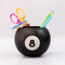 black magic 8 ball shaped vase with desk accessories inside