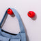 side view of blue baggu bag on cherry shaped hooks