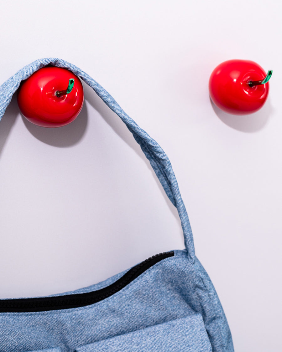 up close of blue baggu bag on cherry shaped hooks