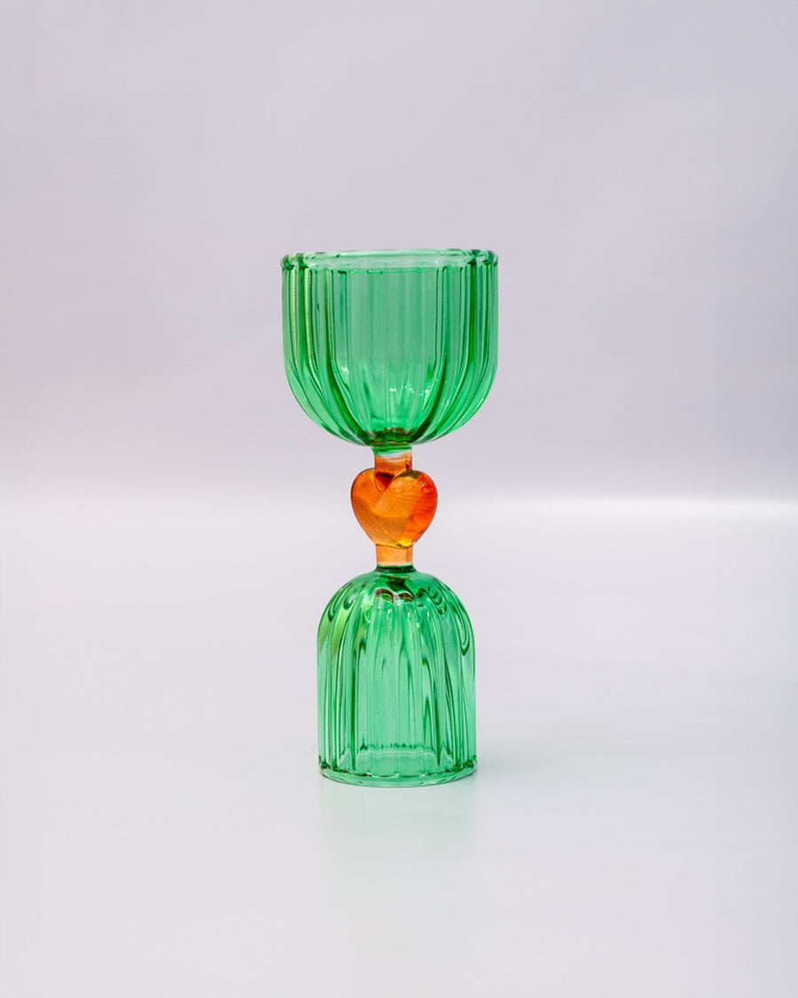 side view of green double shot glass with yellow heart detail