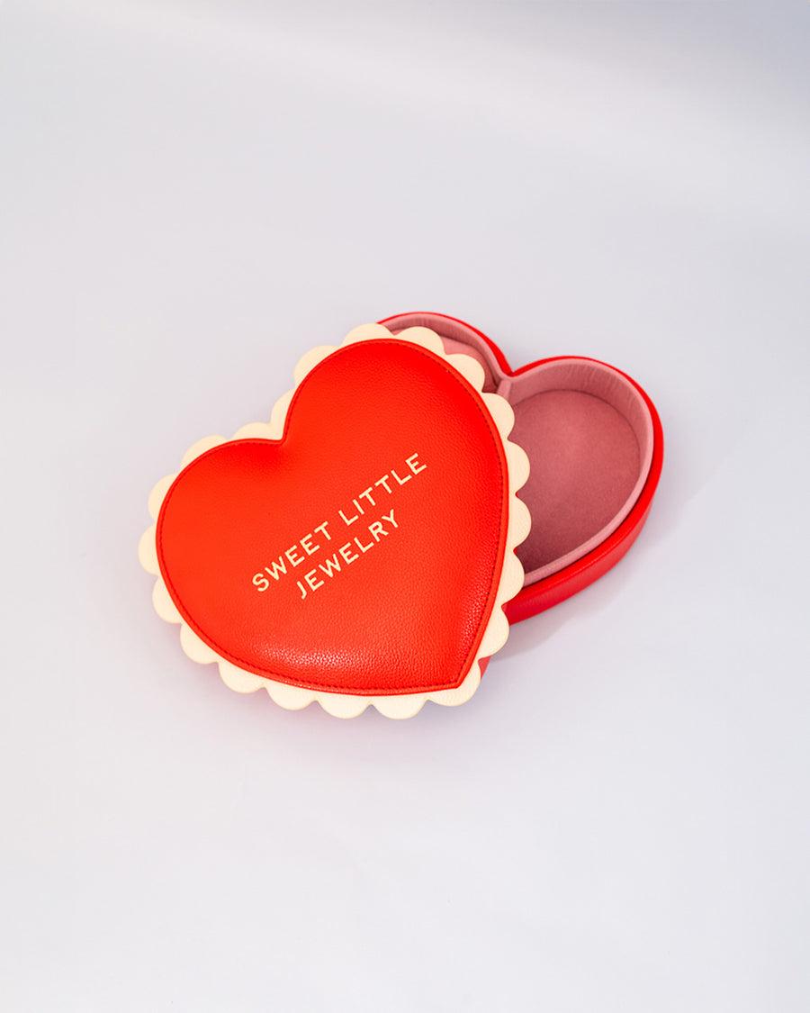 red heart shaped jewelry box with pink interior and cream scalloped detail with 'sweet little jewelry' across the front