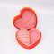 interior of red heart shaped jewelry box with pink interior and cream scalloped detail with 'sweet little jewelry' across the front