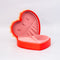 side view of red heart shaped jewelry box with pink interior and cream scalloped detail with 'sweet little jewelry' across the front