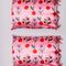 reverse side of pillowcases with all over blue flower, lip, strawberry, and bow print