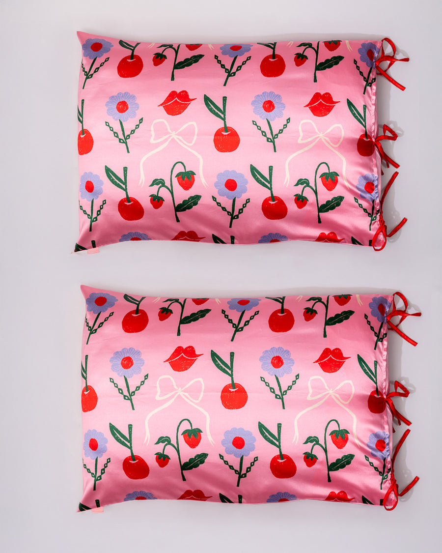 reverse side of pillowcases with all over blue flower, lip, strawberry, and bow print