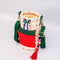 side view of cream quilted water bottle sling with red and green front pouch, green adjustable strap and colorful beaded tassel keychain