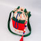 cinched cream quilted water bottle sling with red and green front pouch, green adjustable strap and colorful beaded tassel keychain