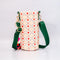 back view of cream quilted water bottle sling with red and green front pouch, green adjustable strap and colorful beaded tassel keychain