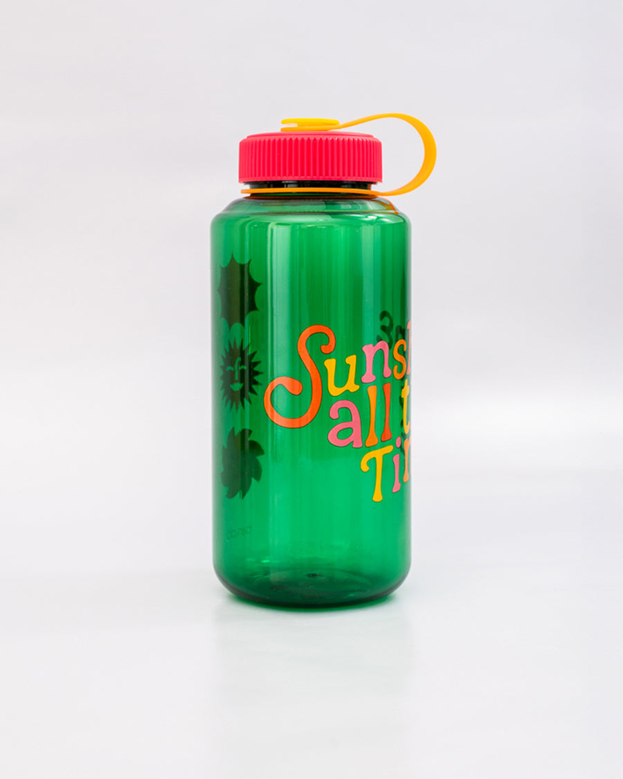 side view of green nalgene like bottle with pink lid, yellow strap and colorful 'sunshine all the time' across the front