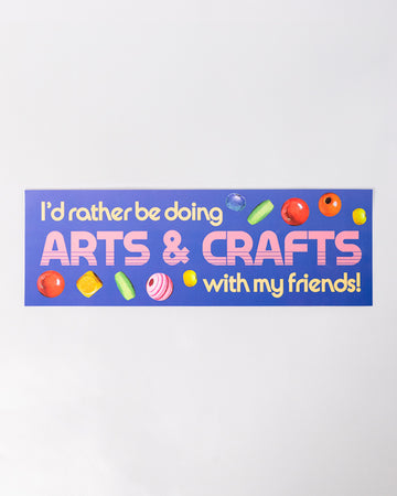 blue bumper sticker with retro 'i'd rather be doing arts & crafts with my friends' typography and bead design