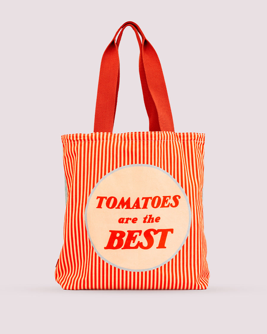 reverse side of tote bag that says 'tomatoes are the best' with yellow and red vertical stripes and red handle