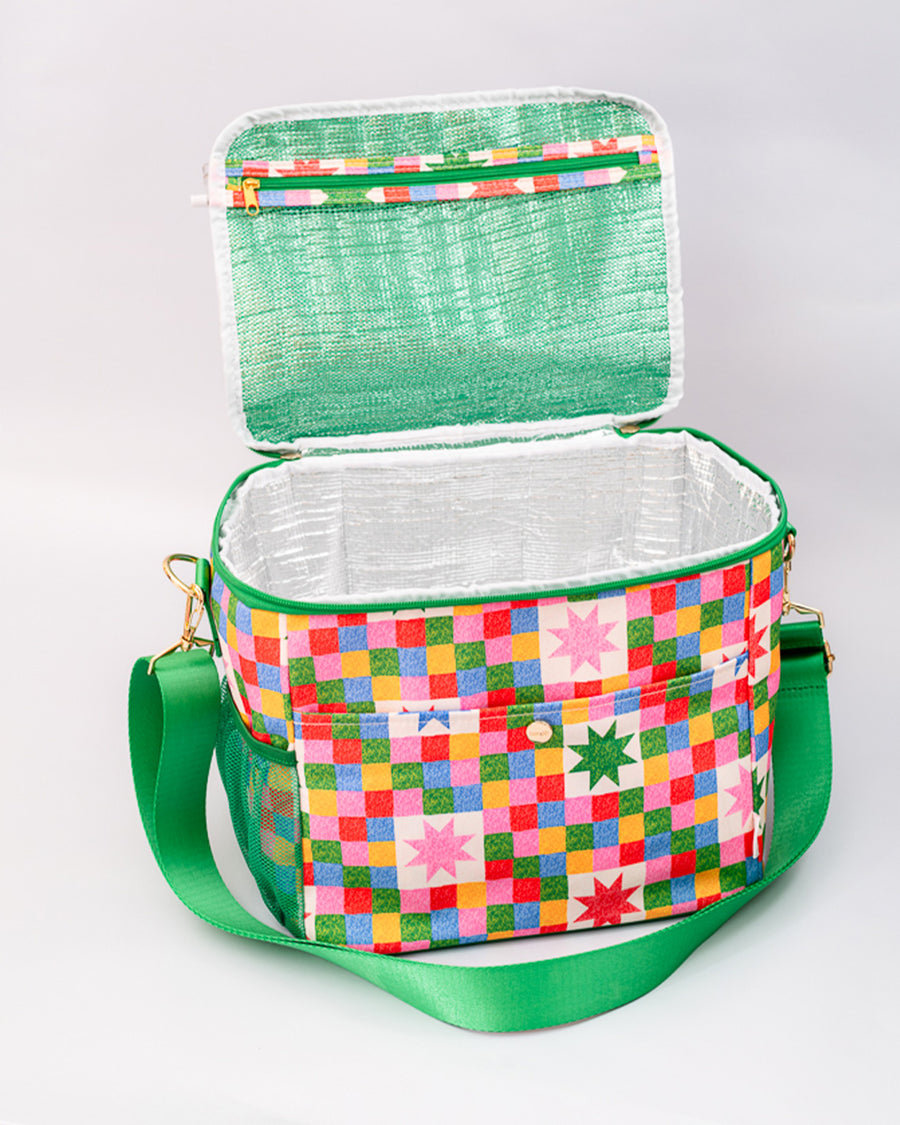 insulated interior of colorful 'quilted' star lunch bag with green trim and strap and front pocket