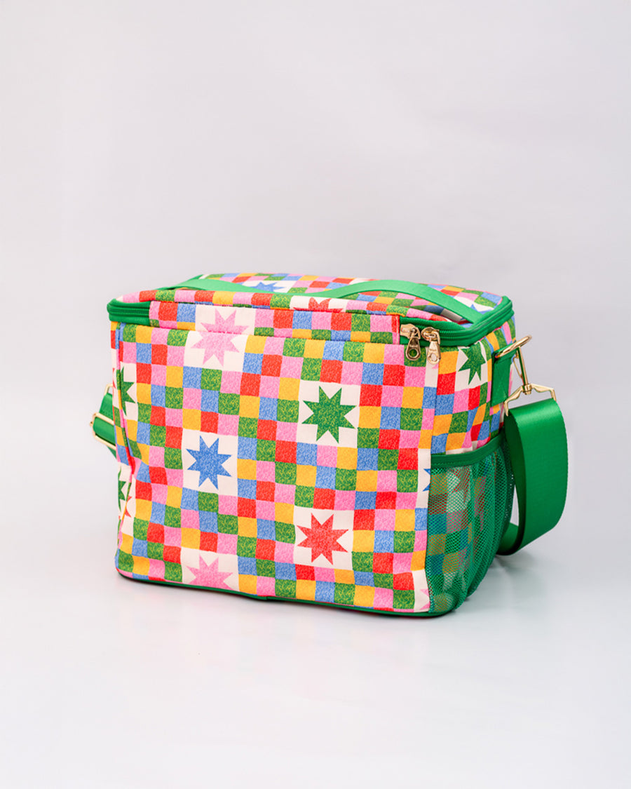 back view of colorful 'quilted' star lunch bag with green trim and strap and front pocket