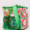 side view of colorful 'quilted' star lunch bag with green trim and strap and front pocket and green mesh side pocket