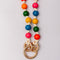 up close of colorful beaded crossbody phone lanyard with gold carabiners