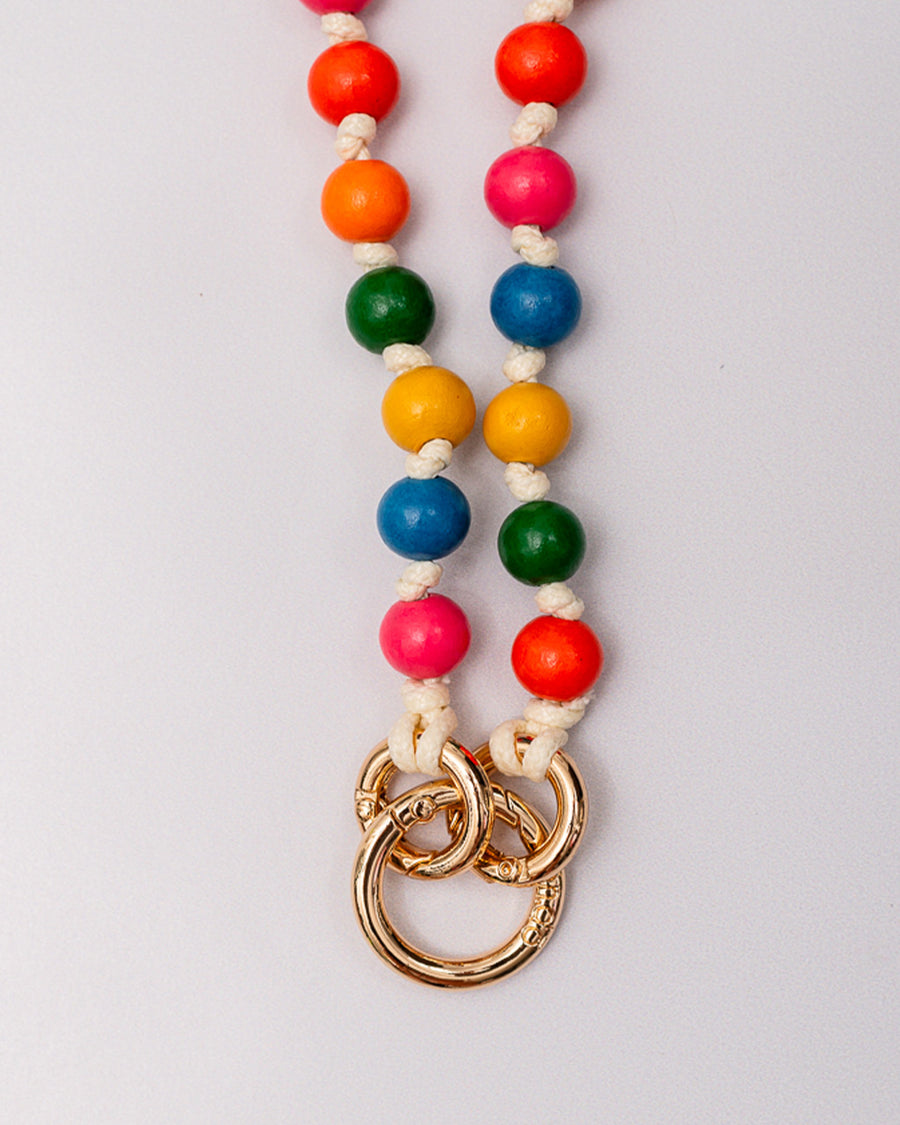 up close of colorful beaded crossbody phone lanyard with gold carabiners