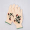 overlapping cream gardening gloves with white flower and strawberry print and green trim