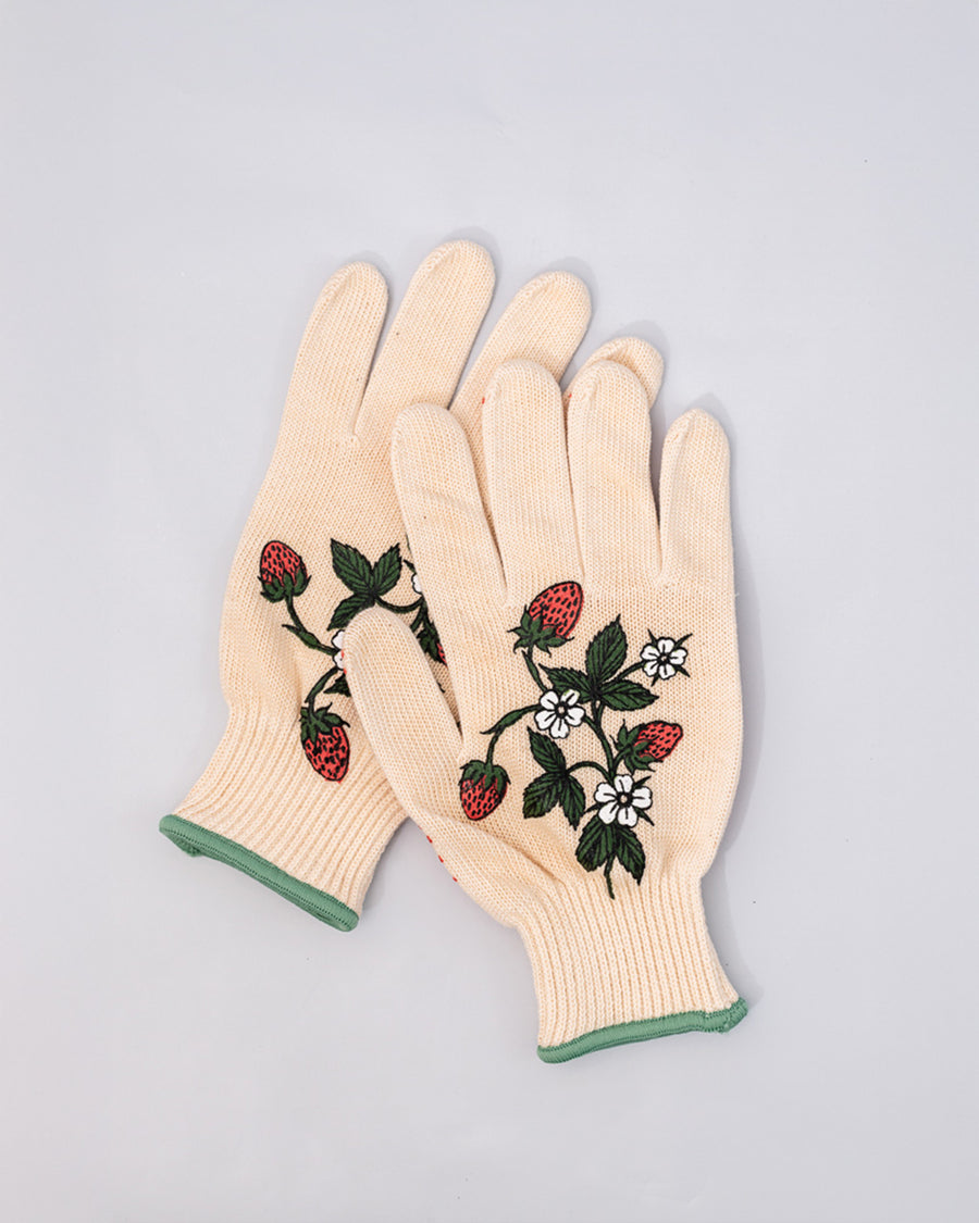 overlapping cream gardening gloves with white flower and strawberry print and green trim