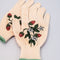 up close of cream gardening gloves with white flower and strawberry print and green trim