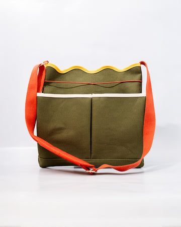 army green canvas gardening tool bag with red strap and yellow scalloped top edge