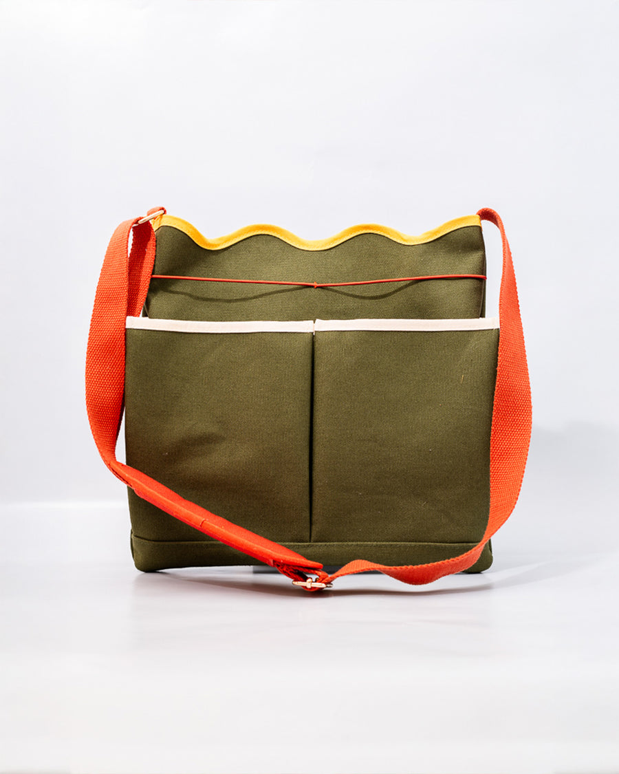 army green canvas gardening tool bag with red strap and yellow scalloped top edge