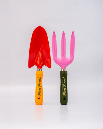 set of two metal gardening tools: red and yellow 'plant parent' towel and pink and green 'plant parent' trident