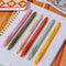 set of 6 colorful clickable pen set with various gardening sayings on a notebook