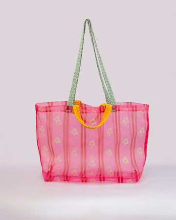 sheer hot pink with floral print and vertical stripes and red and yellow braided straps