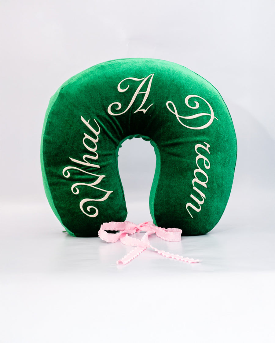 green velvet travel pillow with white 'what a dream' with pink bow