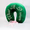 side view of green velvet travel pillow with white 'what a dream' with pink bow