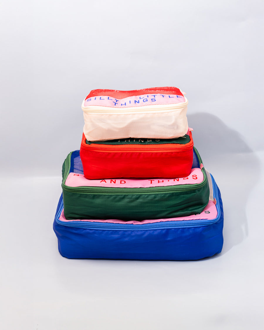 side view of set of 4 packing cubes: silly little things,  sweet little things, bobs and things, and bits and bobs