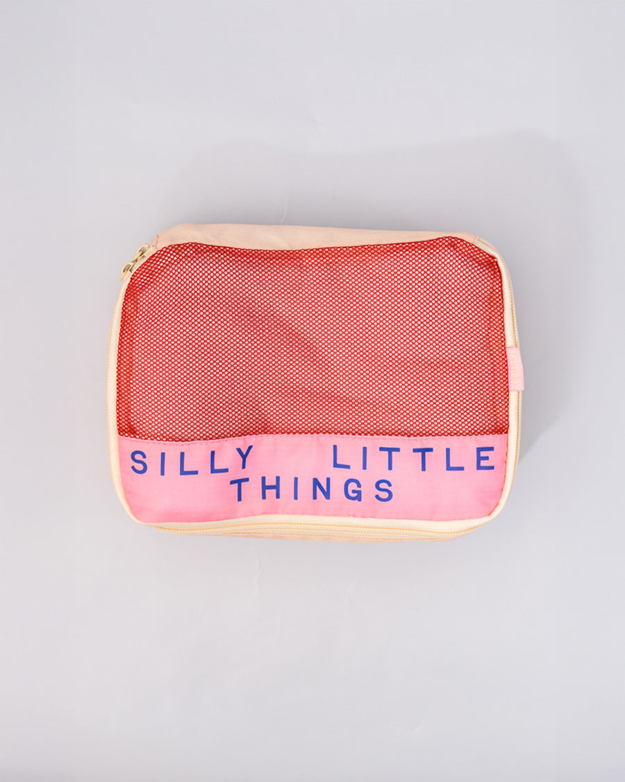 cream and pink small packing cube that says 'silly little things'