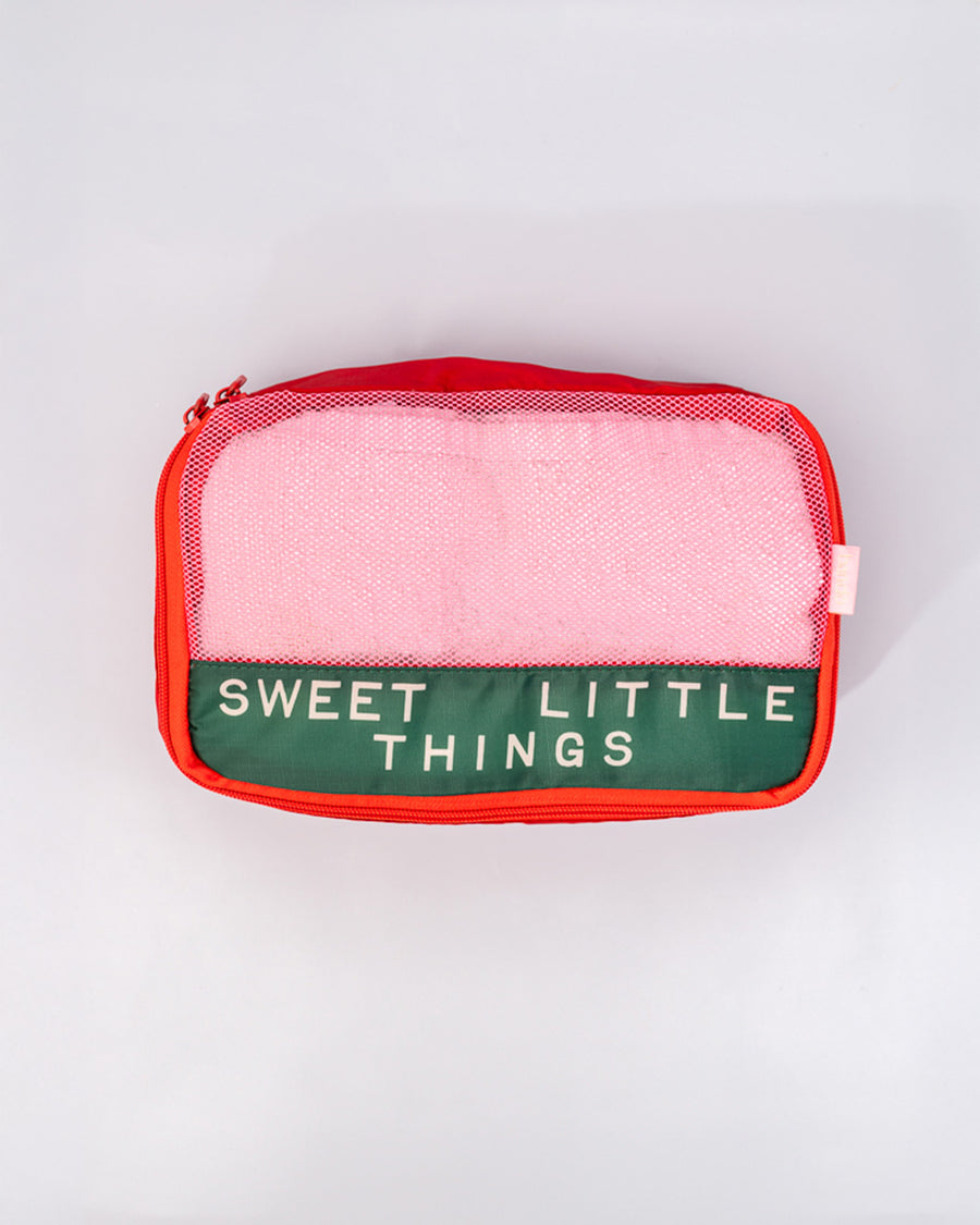 red and green small packing cube that says 'sweet little things'