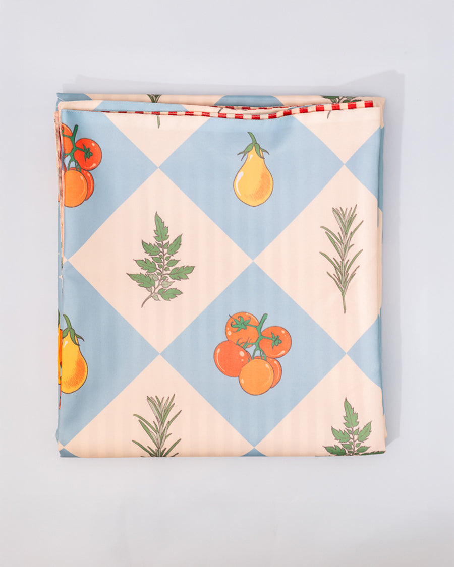 front of double sided picnic blanket with elastic and cream and blue diamond fruit print