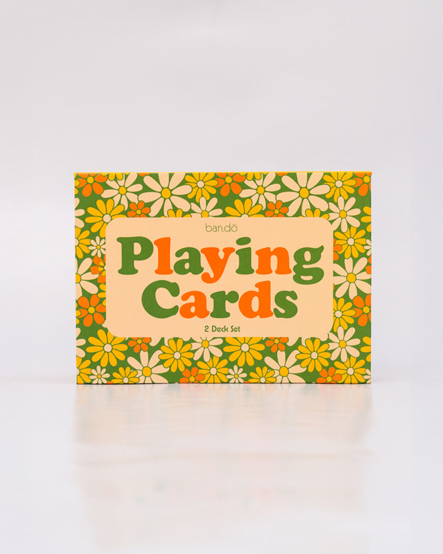 boxed set of two retro floral playing card decks with yellow, gold and green flowers