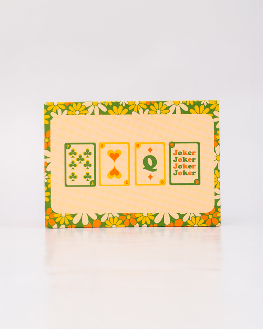 back packaging of set of two retro floral playing card decks with yellow, gold and green flowers