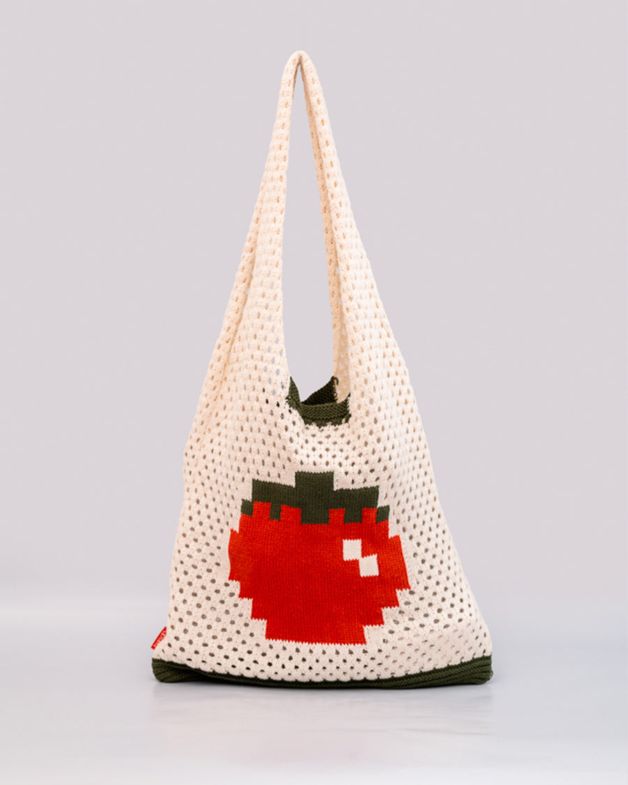 cream open knit market bag with red tomato in the middle and green trim