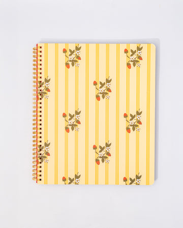 pale yellow large notebook with white floral and strawberry print and dark yellow vertical stripes