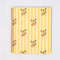 pale yellow large notebook with white floral and strawberry print and dark yellow vertical stripes