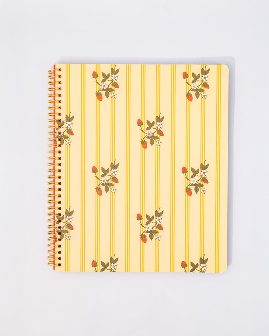 pale yellow large notebook with white floral and strawberry print and dark yellow vertical stripes