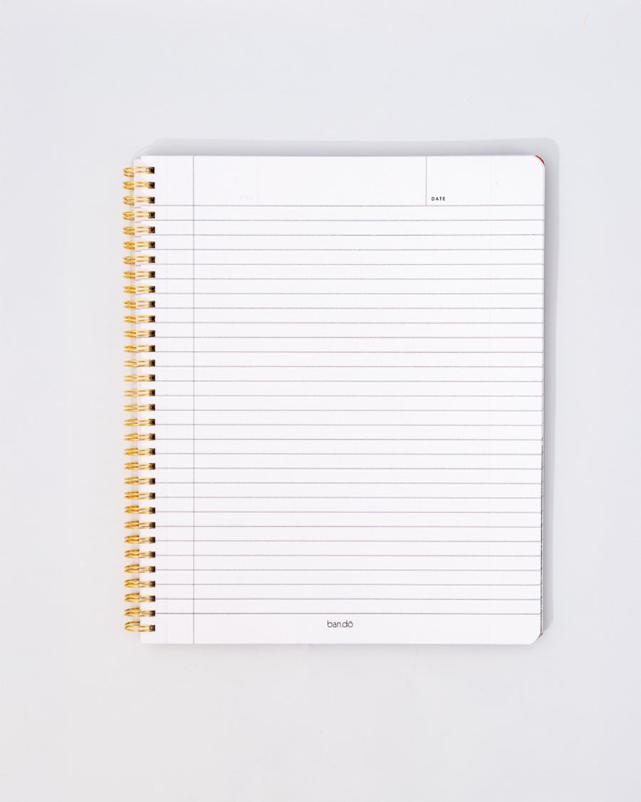 white lined paper inside of pale yellow large notebook with white floral and strawberry print and dark yellow vertical stripes