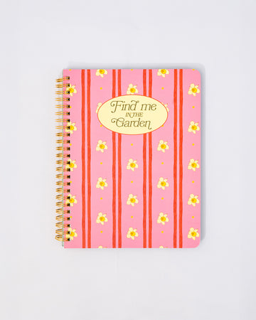 pink mini notebook with vertical double red stripes, realistic daffodil print and cream circle that says 'find me in the garden'