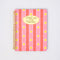 pink mini notebook with vertical double red stripes, realistic daffodil print and cream circle that says 'find me in the garden'