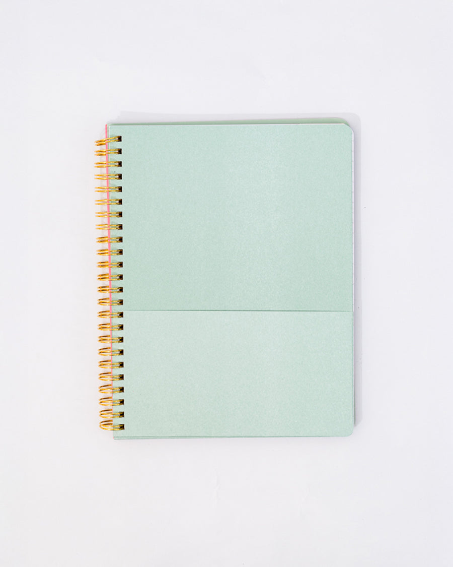 seafoam green interior pocket of pink mini notebook with vertical double red stripes, realistic daffodil print and cream circle that says 'find me in the garden'